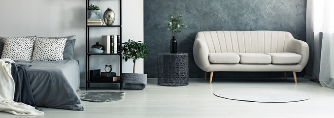 Sofa in bright grey bedroom