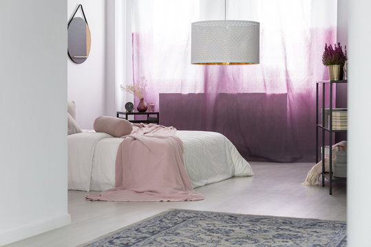 Designer's bedroom with white lamp