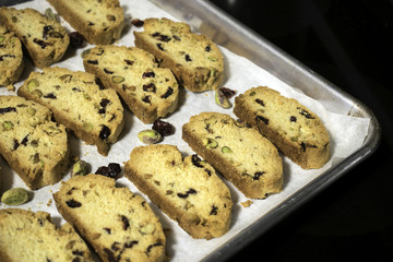 Just out of the oven are cookies with pistachios and dried cranberries.