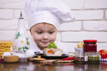 funny boy chef prepares meat rolls