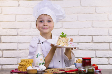 funny boy chef preparing salad Olivier