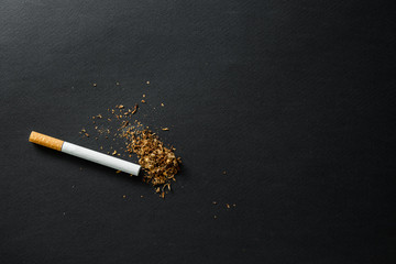 Broken cigarette on a dark background. quit Smoking