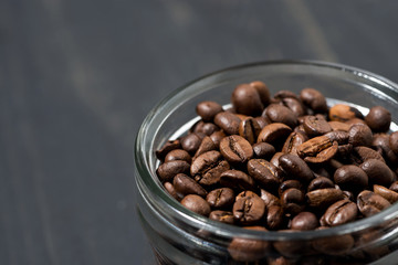 jar of coffee beans on a wooden background, concept photo