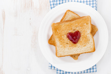 toast with jam in the shape of a heart for Valentine's Day, top view