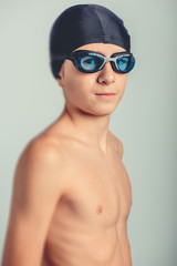 young swimmer with goggles and swimming cap