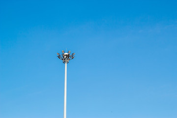 light pole tower in sport arena on blue sky