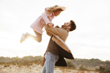 Happy father having fun with his little daughter