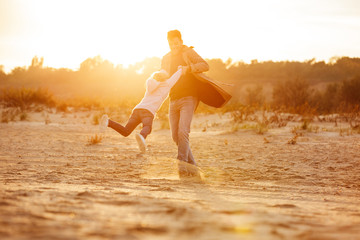 Cheerful father playing with his little daughter - Powered by Adobe