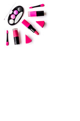 Makeup set pattern. Eyeshadows, lipstick, nailpolish on white background top view copyspace