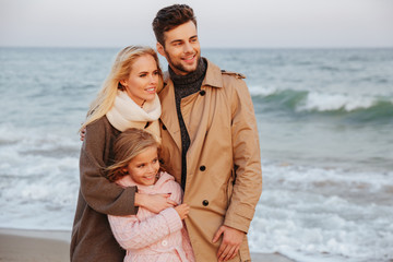 Portrait of a cheerful family with a little daughter