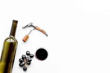 Obraz na płótnie Canvas Open the wine. Corkscrew near bottle, glass, grape on white background top view copyspace