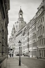 Street in the old town of Dresden with the rebuilt Frauenkirche in the background