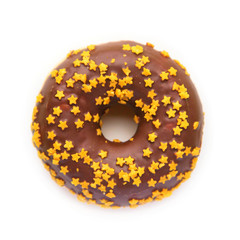 Christmas donut with chocolate icing and golden stars.