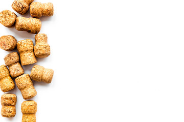 Wine bottle corks pattern on white background top view copyspace. New Year celebration concept