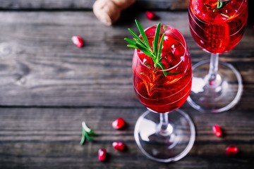 Pomegranate champagne mimosa cocktail with rosemary © nblxer