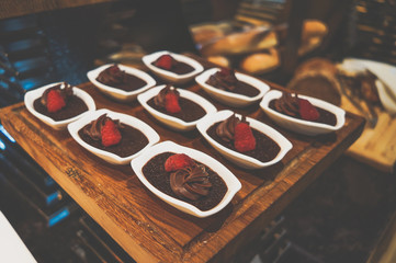 Delicious desserts on the tray. Delicious chocolate desserts and mousses. Toning.
