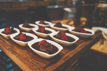 Delicious desserts on the tray. Delicious chocolate desserts and mousses. Toning.
