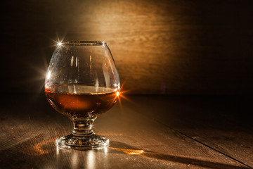 Cognac drinks glass on dark background