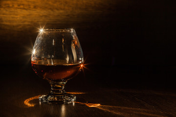 Cognac drinks glass on dark background