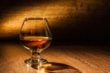 Cognac drinks glass on dark background