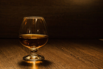 Cognac drinks glass on dark background