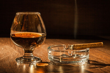 Cognac drinks glass on dark background