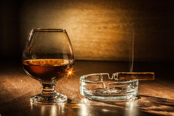 Cognac drinks glass on dark background