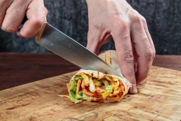 roll with chicken, cabbage, lettuce, and spices wrapped in Eastern flatbread and grilled. fast food.