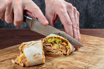 roll with chicken, cabbage, lettuce, and spices wrapped in Eastern flatbread and grilled. fast food.