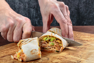 roll with chicken, cabbage, lettuce, and spices wrapped in Eastern flatbread and grilled. fast food.