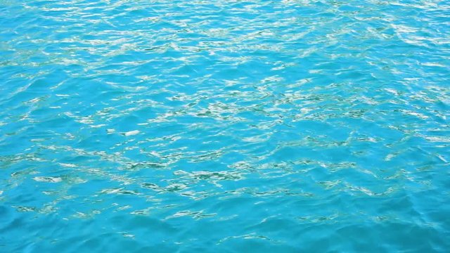 Surface of clean turquious sea water with waves