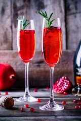 Pomegranate champagne mimosa cocktail with rosemary