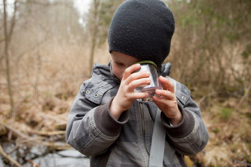 Boy examining something in a glass