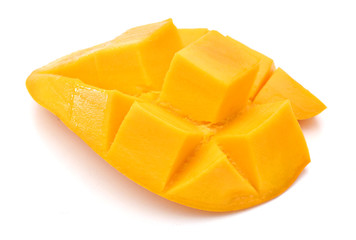 Mango slice cut to cubes close-up isolated on white background