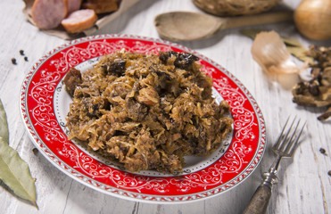 Cabbage stew with meat, mushrooms and dried plums - traditional polish dish