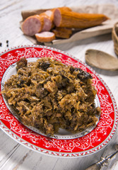 Cabbage stew with meat, mushrooms and dried plums - traditional polish dish