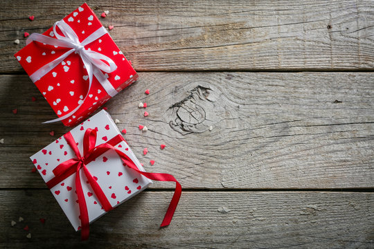 Valentine's day concept - presents, candy, glasses on rustic wood background