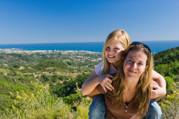 Mother and daughter piggyback ride