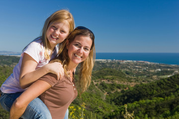 Mother and daughter piggyback ride