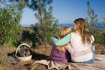 Mother and daughter hugging rural scene
