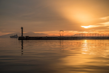 Fototapeta na wymiar Thessaloniki Port View, Lighthouse, using tilt and shif lens, Golden Hour