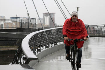 Man in raincoat cycling