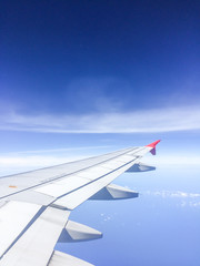 Fototapeta premium Morning blue sky with Wing of an airplane.