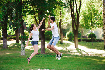 A young couple celebrate victory playing tic-tac-toe in the park