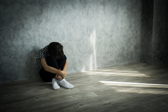 Sad Teenager Boy Sitting Alone Lonely On The Floor Leaning Against The Wall