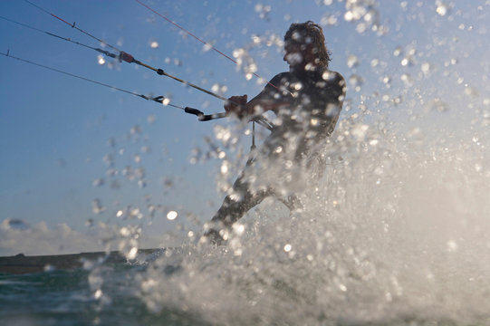 Kite surfer splashing in water