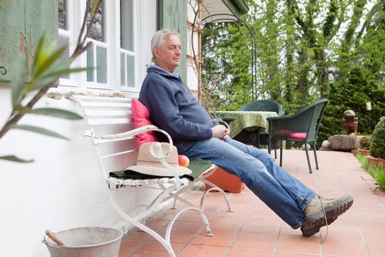 Older Man Sitting On Porch