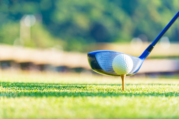 Golf ball and tee on green grass background.Golfers hit sweeping and keep golf course in the summer for relax time.