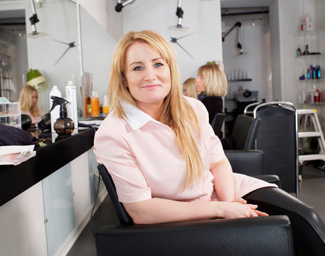 Hairdresser Sitting In Salon Chair