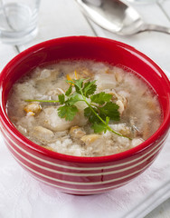 Fish soup served in a red bowl